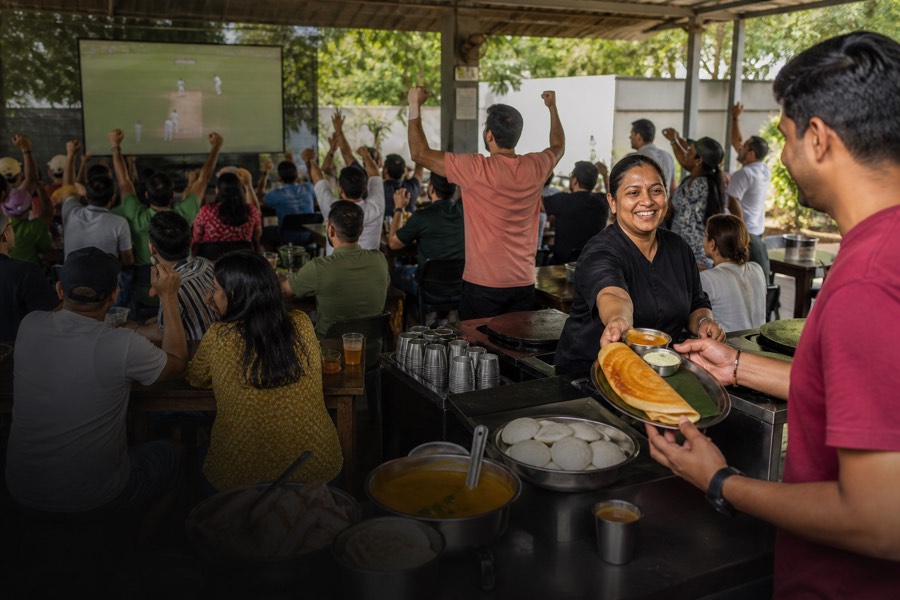Dosai served to a crowd watching cricket on a big screen